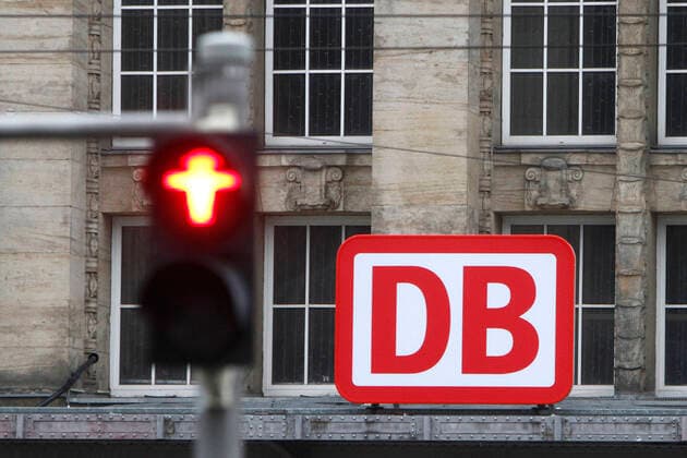 Logo of Deutsche Bahn DB behind a red pedestrian light at Leipzig central station, Saxony, Germany