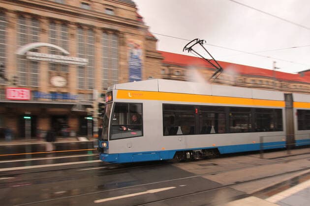 A tram of the Leipzig public transport company LVB runs in front of the central station Leipzig, Saxony, Germany