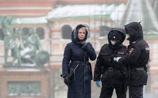 MOSCOW, RUSSIA - MARCH 31, 2020: Police officers checking a woman s documents in Red Square. Russian President Vladimir Putin declared a week off work from March 28 through April 5, 2020, and urged people to stay home to prevent the spread of the COVID-19 coronavirus. The Russian capital s authorities imposed home isolation for all Moscow residents, regardless of their age, and restrictions on movement within the city, effective from March 30, 2020, as a measure to contain the spread of the COVID-19 coronavirus infection. Sergei Savostyanov TASS  TS0D3FD7