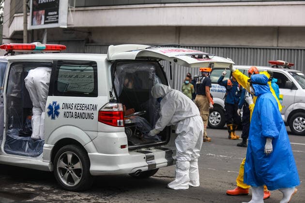 Incident on the street amid fears of coronavirus outbreak in Indonesia - 31 March 2020. EDITORS NOTE: Graphic content Health officials wearing protective suits evacuate a man after he allegedly collapsed on the street in Bandung, West Java, Indonesia, March 31, 2020. amid fears of coronavirus outbreak. (Photo by Agvi Firdaus INA Photo Agency imago images) 