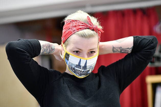 A staff member puts on a self-made facial mask at a tailor shop in Cologne, Germany, March 31, 2020. Confirmed cases of COVID-19 in Germany increased (Photo by Xinhua) GERMANY-COLOGNE-COVID-19 UlrichxHufnagel 