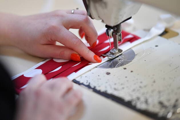 A staff member of a tailor shop makes a facial mask at the shop in Cologne, Germany, March 31, 2020. Confirmed cases of COVID-19 in Germany increased (Photo by Ulrich Hufnagel Xinhua) GERMANY-COLOGNE-COVID-19 