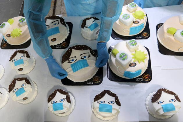 March 31, 2020, Khan Yunis, Gaza Strip, Palestinian Territory: Palestinians put final touches on cakes that portrays a woman wearing a facemask with model of bottel of Dettol to sterilize, at their shop in Khan Yunis in the southern Gaza Strip on March 31, 2020. The United Nations has warned that a COVID-19 outbreak in Gaza could be disastrous, given the high poverty rates and weak health system in the coastal strip under Israeli blockade since 2007. Authorities in Gaza have said that more than 2,700 Palestinians are in home-isolation, mostly people who had returned from Egypt Khan Yunis Palestinian Territory - ZUMAap3_ 20200331_zaf_ap3_102 Copyright: xAshrafxAmrax