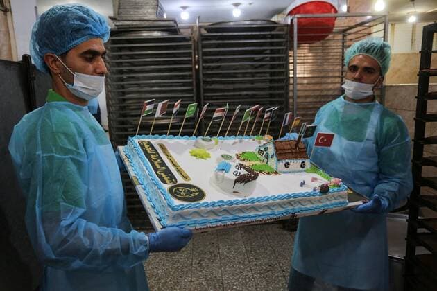March 31, 2020, Khan Yunis, Gaza Strip, Palestinian Territory: Palestinians put final touches on cakes that portrays a woman wearing a facemask with model of bottel of Dettol to sterilize, at their shop in Khan Yunis in the southern Gaza Strip on March 31, 2020. The United Nations has warned that a COVID-19 outbreak in Gaza could be disastrous, given the high poverty rates and weak health system in the coastal strip under Israeli blockade since 2007. Authorities in Gaza have said that more than 2,700 Palestinians are in home-isolation, mostly people who had returned from Egypt Khan Yunis Palestinian Territory - ZUMAap3_ 20200331_zaf_ap3_124 Copyright: xAshrafxAmrax
