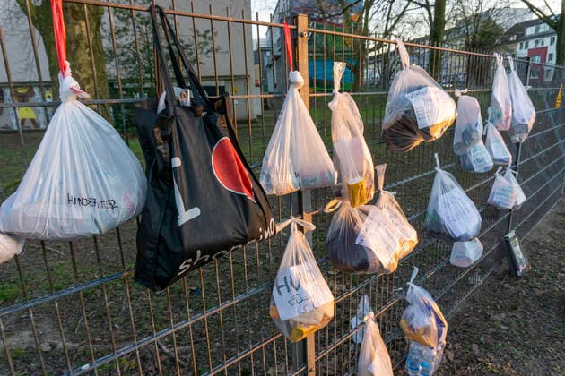 Gift fence with donations for the homeless and needy, food, hygiene articles, clothing, in Essen Rüttenscheid, effects of the corona crisis in Germany,