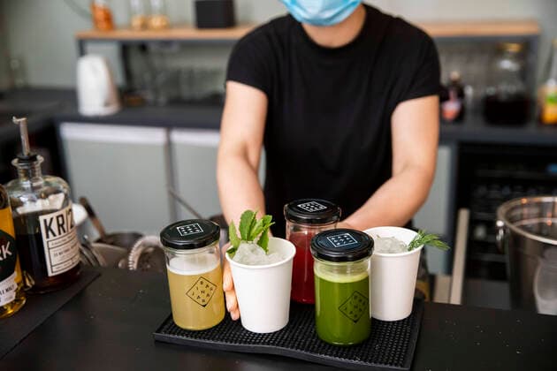 Izabela Rosiak prepares cocktails with a face mask in the bar in the Jar in B