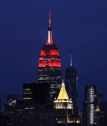 The Empire State Building light display is lit in the red and white colors of the Red Cross intended to honor emergency workers fighting coronavirus on Tuesday March 31, 2020 in New York City. The iconic Midtown skyscraper announced the debut of a display that began at 9 p.m. Monday, and will continue on through the course of the ongoing pandemic. New York s cases have topped 75,000 and 1,550 people have died.  NYP20200331132 JOHNxANGELILLO