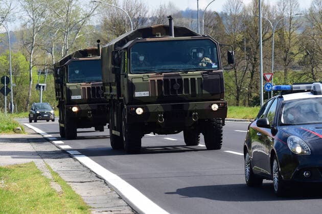 (200331) -- BOLOGNA (ITALY), March 31, 2020 (Xinhua) -- Military trucks carrying bodies of patients who died from COVID-19 infections from Lombardy arrive in Bologna, Italy, on March 31, 2020. The COVID-19 pandemic continued to advance in locked down Italy on Tuesday, bringing the total number of infections, fatalities and recoveries to 105,792, according to the latest data released by the country s Civil Protection Department. (Photo by Gianni Schicchi Xinhua) ITALY-BOLOGNA-COVID-19-CASES 