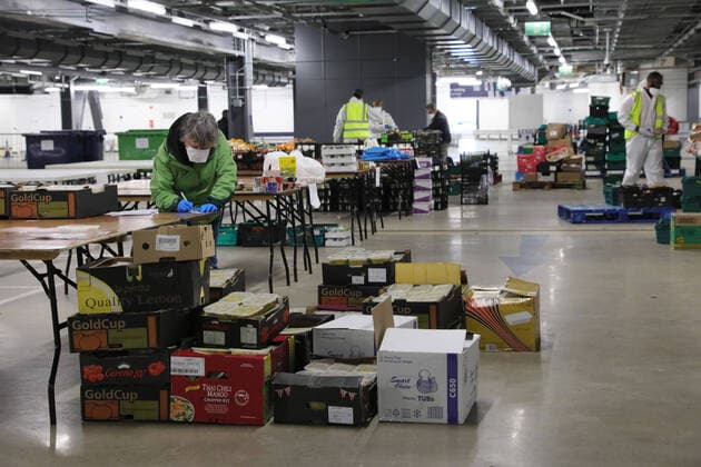 (200401) -- LONDON, April 1, 2020 (Xinhua) -- Volunteers prepare food and meals at a distribution hub in the underground car parking lot at Tottenham Hotspur Stadium in London, Britain, March 31, 2020. The distribution hub was set up by the charity Edible London, working in partnership with Haringey Council, for food distribution to vulnerable groups and workers of National Health Service (NHS). The British Government continues to try to combat the COVID-19 outbreak, while local authorities, community groups and charities are working to provide food for the most vulnerable in society. (Photo by Tim Ireland Xinhua) BRITAIN-LONDON-COVID-19-FOOD DISTRIBUTION 