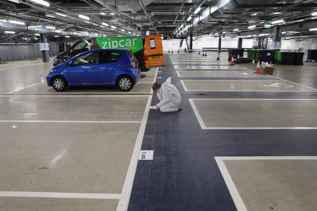 (200401) -- LONDON, April 1, 2020 (Xinhua) -- A volunteer marks parking spaces for delivery vehicles at a distribution hub in the underground car parking lot at Tottenham Hotspur Stadium in London, Britain, March 31, 2020. The distribution hub was set up by the charity Edible London, working in partnership with Haringey Council, for food distribution to vulnerable groups and workers of National Health Service (NHS). The British Government continues to try to combat the COVID-19 outbreak, while local authorities, community groups and charities are working to provide food for the most vulnerable in society. (Photo by Tim Ireland Xinhua) BRITAIN-LONDON-COVID-19-FOOD DISTRIBUTION 