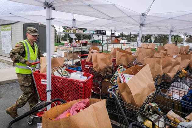 March 31, 2020, Columbus, Ohio, United States: A member of the Ohio National Guard helps to pack food and supplies for those in need at the Mid Ohio Foodbank in Columbus..Due to the ongoing Coronavirus Pandemic and rising unemployment, the demand placed on Foodbanks around the United States has grown rapidly. The National Guard has been deployed to assist with the stocking, packaging, and distribution of food throughout the state. Columbus United States - ZUMAs197 20200331_zaa_s197_109 Copyright: xMatthewxHatcherx
