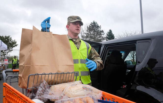 March 31, 2020, Columbus, Ohio, United States: Members of the Ohio National Guard help to pack food and supplies for those in need at the Mid Ohio Foodbank in Columbus..Due to the ongoing Coronavirus Pandemic and rising unemployment, the demand placed on Foodbanks around the United States has grown rapidly. The National Guard has been deployed to assist with the stocking, packaging, and distribution of food throughout the state. Columbus United States - ZUMAs197 20200331_zaa_s197_111 Copyright: xMatthewxHatcherx