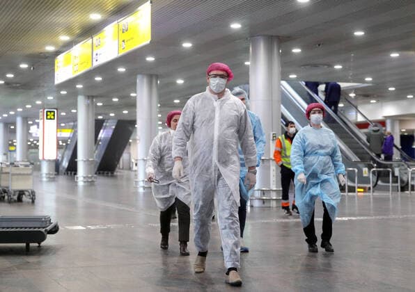 MOSCOW REGION, RUSSIA - APRIL 1, 2020: Medical workers in protective gear at the arrivals area of Terminal D of Sheremetyevo International Airport. The airport shuts down Terminal D from April 1, 2020 due to decrease of passenger flow amid the COVID-19 coronavirus pandemic. All international fligths are transferred to Terminal F, internal to Terminal B. Sergei Bobylev TASS  TS0D4083