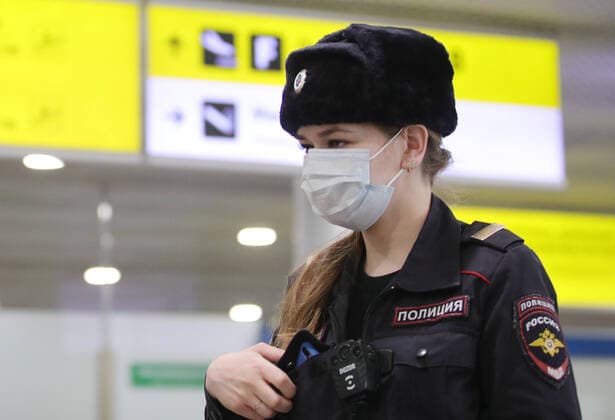 MOSCOW REGION, RUSSIA - APRIL 1, 2020: A police officer in a medical mask at Terminal D of Sheremetyevo International Airport where Russian citizens have arrived from New Delhi. The airport shuts down Terminal D from April 1, 2020 due to decrease of passenger flow amid the COVID-19 coronavirus pandemic. All international flights are transferred to Terminal F, internal to Terminal B. Sergei Bobylev TASS  TS0D40A0