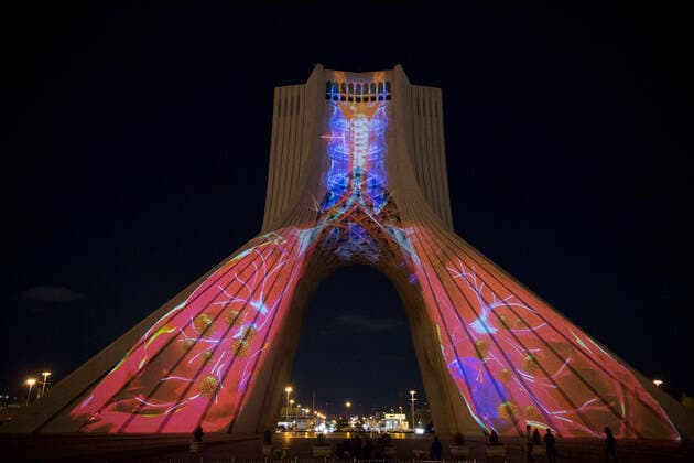 March 31, 2020, Tehran, Iran: A view at night of the lit-up Azadi (Freedom) tower with flags, messages of sympathy from all over the world over the ongoing novel coronavirus disease (COVID-19) pandemic, in Tehran, Iran. The appreciation message was also reflected in healthcare professionals who are trying to stop the pandemic in the country. The light display was organized by the city municipality. According to the latest reports by the Iranian Ministry of Health, over 2,000 people have died from the coronavirus infection throughout the country. Tehran Iran - ZUMAf146 20200331_zip_f146_016 Copyright: xRouzbehxFouladix