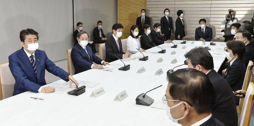 New coronavirus Japanese Prime Minister Shinzo Abe (L) attends a meeting of the government s coronavirus task force on April 1, 2020, in Tokyo. 