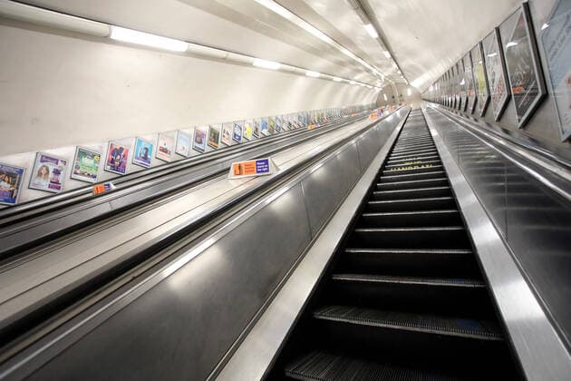 Day Nine of Lockdown in London. The empty underground escalators at Green Park, with a sign informing people to keep their distance. The country is on lockdown due to the COVID-19 Coronavirus pandemic. People are not allowed to leave home except for minimal food shopping, medical treatment, exercise - once a day, and essential work. COVID-19 Coronavirus lockdown, London, UK, on April 1, 2020 
