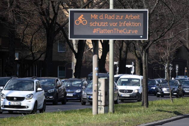 A display at Tempelhofer Damm indicates Berlin-wide contact restrictions due to the Corona Virus and the need to cycle to work Berlin-wide contact restrictions due to Corona
