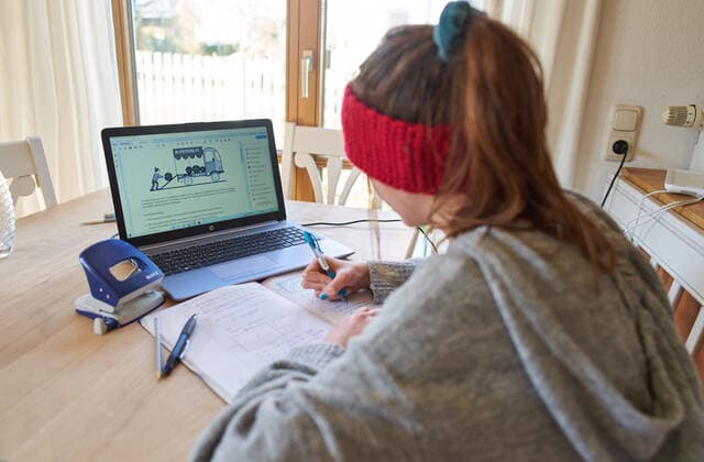 Kaufbeuren, Germany, April 01, 2020. Students are learning at home with computer and iphone due to the Corona virus disease (COVID-19) on April 01, 2020 in Kaufbeuren, Germany Model released