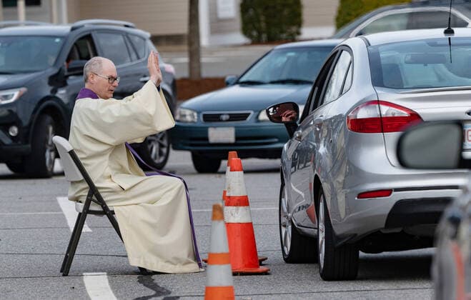 April 1, 2020, Chelmsford, Massachusetts, USA: Father Brian Mahoney hears at drive-up confessions in the parking lot of St. Marys Catholic Church during Covid-19 pandemic in Chelmsford.  (124964596)