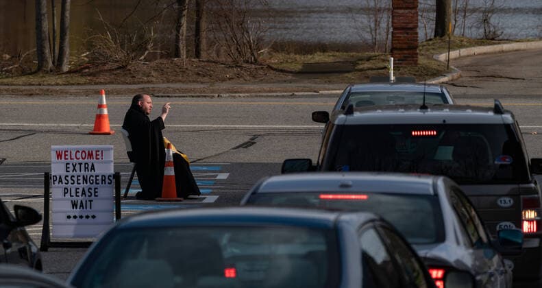 April 1, 2020, Chelmsford, Massachusetts, USA: Father Corey Bassett-Tirrell hears at drive-up confessions in the parking lot of St. Mary Catholic Church during Covid-19 pandemic in Chelmsford.  (124964600)