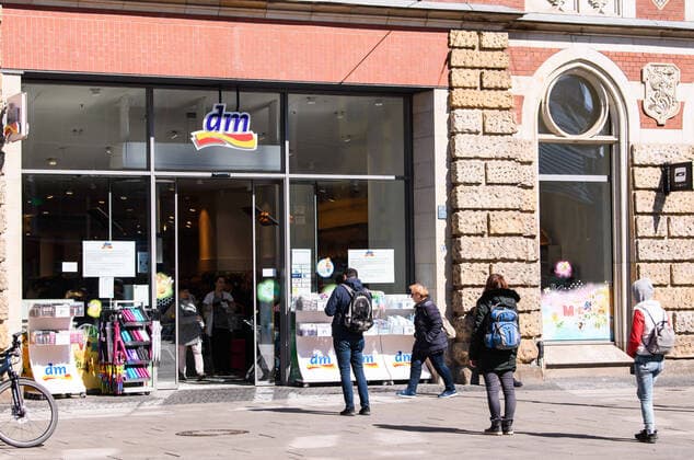 (200401) -- ERFURT (GERMANY), April 1, 2020 (Xinhua) -- People queue with a distance to enter a DM store in Erfurt, central Germany, on April 1, 2020. Germany will extend the restrictions on social contacts to April 19 at the earliest, in a bid to contain the COVID-19 spreading, Chancellor Angela Merkel said following a video conference with minister-presidents of all 16 federal states. (Photo by Kevin Voigt Xinhua) GERMANY-ERFURT-COVID-19-RESTRICTIONS 