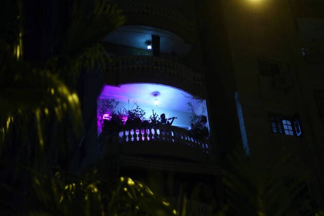 (200402) -- CAIRO, April 2, 2020 -- Egyptian violinist Mohammed Adel plays the violin during his balcony concert in Cairo, Egypt on March 31, 2020. Every night, Egyptian violinist Mohammed Adel gives a live concert from his balcony to entertain his neighbors during a coronavirus-caused nationwide nighttime curfew. TO GO WITH: Feature: Egyptian violinist s balcony performances amuse neighbors during nighttime curfew ) EGYPT-CAIRO-CURFEW-BALCONY CONCERT AhmedxGomaa 