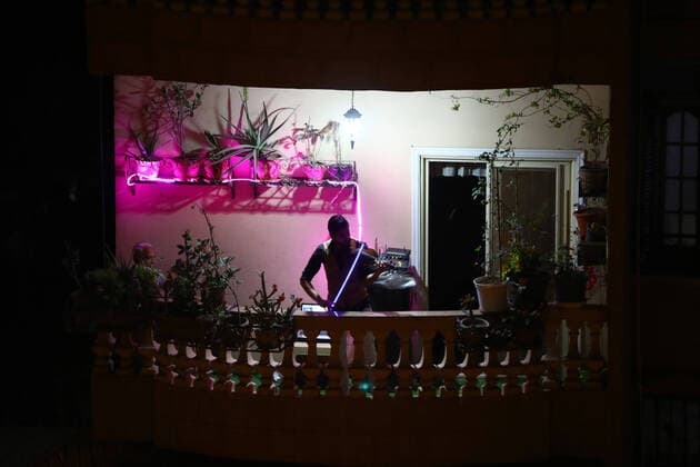 (200402) -- CAIRO, April 2, 2020 -- Egyptian violinist Mohammed Adel plays the violin during his balcony concert in Cairo, Egypt on March 31, 2020. Every night, Egyptian violinist Mohammed Adel gives a live concert from his balcony to entertain his neighbors during a coronavirus-caused nationwide nighttime curfew. TO GO WITH: Feature: Egyptian violinist s balcony performances amuse neighbors during nighttime curfew ) EGYPT-CAIRO-CURFEW-BALCONY CONCERT AhmedxGomaa 