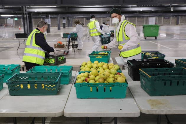 (200402) -- LONDON, April 2, 2020 (Xinhua) -- Volunteers work at a distribution hub for distribution of food to vulnerable groups, in London, Britain on April 1, 2020. The distribution hub was set up Monday by the Edible London food project, working in partnership with Haringey Council, in the underground car park at Tottenham Hotspur Stadium in London, for distribution of food to vulnerable groups. The British Government continues to try to combat the Coronavirus outbreak, while local authorities, community groups and charities are working to provide food for the most vulnerable in society. (Photo by Tim Ireland Xinhua) BRITAIN-LONDON-COVID-19-FOOD DISTRIBUTION