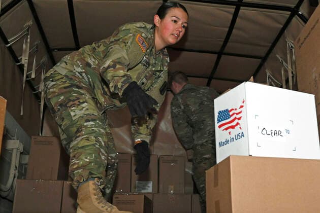 March 30, 2020 - Concord, New Hampshire, USA - Spc. Kristina Sherman, 3643d Brigade Support Battalion, Headquarters and Service Company, New Hampshire Army National Guard, loads boxes of personal protective equipment onto a military cargo truck in Concord, March 30, 2020. The equipment, to include latex gloves and face masks, was shipped in preparation for potential COVID-19 support operations. Concord USA - ZUMAz03_ 20200330_sha_z03_403 Copyright: xU.S.xNationalxGuardx