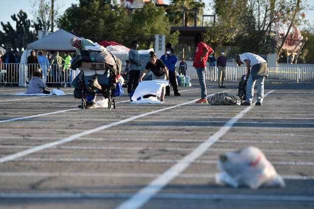 April 1, 2020 - Las Vegas, Nevada, U.S. - People prepare a place to sleep in an area marked by painted boxes at a temporary homeless shelter set up in a parking lot at Cashman Center amid the coronavirus pandemic on April 1, 2020, in Las Vegas, Nevada. Local officials opened the makeshift shelter after another local shelter closed when a homeless man staying there tested positive for the coronavirus. Las Vegas USA - ZUMAbk3_ 20200401_zaf_bk3_002 Copyright: xDavidxBeckerx