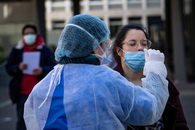 (200402) -- PARIS, April 2, 2020 (Xinhua) -- A medical biologist handles a swab to test a mediacal worker for the COVID-19 disease at a COVID-19 drive-in test center in Paris, France, April 1, 2020. A COVID-19 drive-in and screening center has opened at the City Hall of the 17th arrondissement of Paris in partnership with three laboratories in the arrondissement and is dedicated to healthcare professionals. (Photo by Aurelien Morissard Xinhua) FRANCE-PARIS-CORONAVIRUS-DRIVE IN TEST 