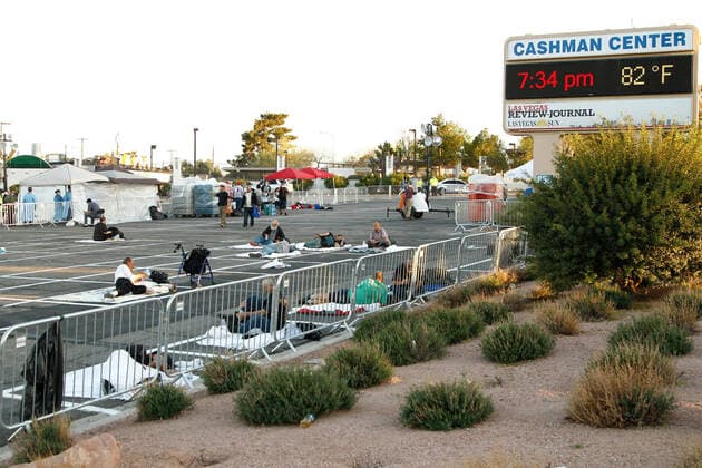 Members of the homeless community practice self-distancing measures at a temporary shelter at the Cashman Center parking lot during the Coronavirus closure of Hotels and Casino s in Las Vegas, Nevada on Wednesday, April 1, 2020.  LAV2020040103 JAMESxATOA