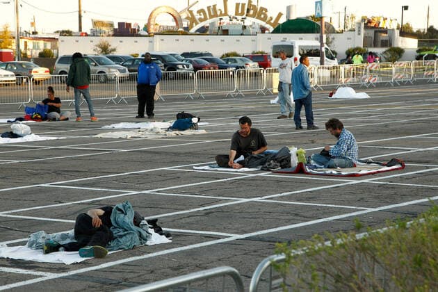 Homeless individuals practice self-distancing measures at a temporary open air shelter at the Cashman Center parking lot during the Coronavirus closure of Hotels and Casino s in Las Vegas, Nevada on Wednesday, April 1, 2020.  LAV2020040106 JAMESxATOA