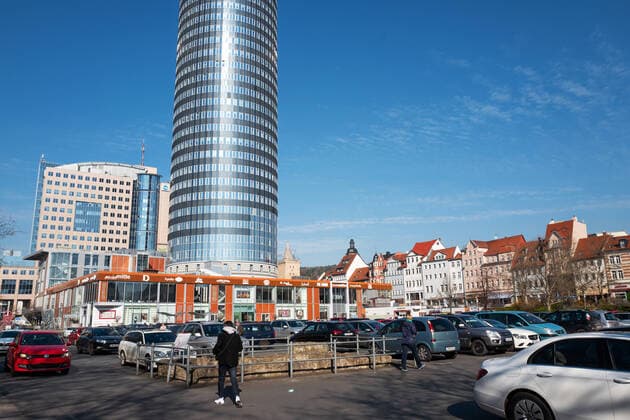The Eichplatz in the center of Jena is full of parked cars in the morning of 2 4 2020 In the background the Jentow city center of Jena
