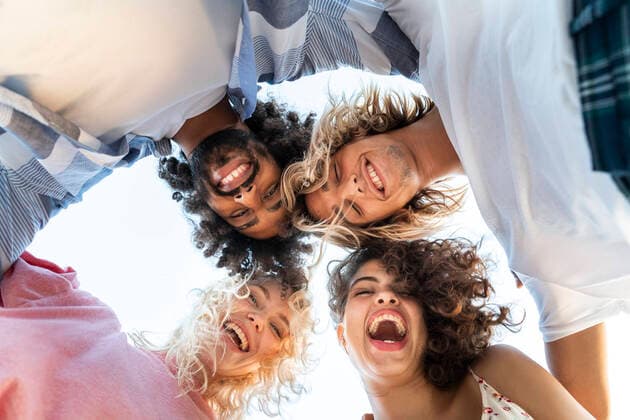 Portrait of happy friends huddling outdoors model released Symbolfoto  AFVF05513