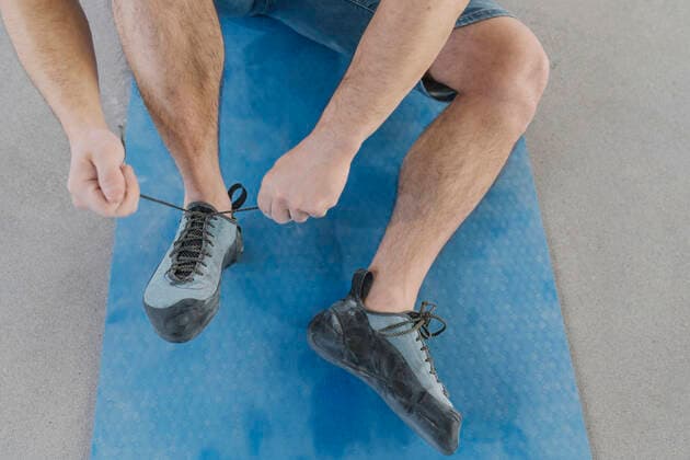 Close-up of man putting on climbing shoes model released Symbolfoto property released  AHSF01932