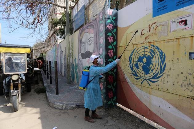 April 2, 2020, Dair Al Balah, Gaza Strip, Palestinian Territory: Palestinian workers spray disinfectant outside an UNRWA school as a preventive measure amid fears of the spread of the coronavirus disease (COVID-19), in Dair Al Balah in the center of Gaza strip, on April 2, 2020 Dair Al Balah Palestinian Territory - ZUMAap3_ 20200402_zaf_ap3_052 Copyright: xAshrafxAmrax