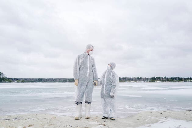 Father and son wearing protective suits standing at frozen river model released Symbolfoto  EYAF00983