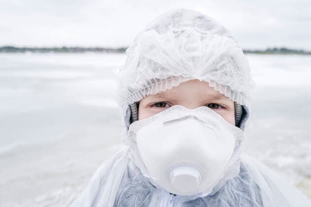 Portrait of boy wearing protective suit and mask model released Symbolfoto  EYAF00984
