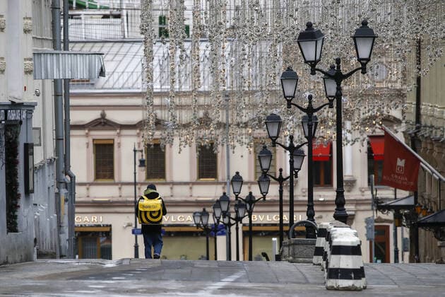 MOSCOW, RUSSIA - APRIL 2, 2020: A courier of a food delivery service seen in Kuznetsky Most Street. The Moscow authorities imposed home isolation for all Moscow residents, regardless of their age, and restrictions on movement within the city, effective since March 30, 2020, as a measure to contain the spread of the COVID-19 coronavirus infection. Violations of the stay-at-home order carry fines ranging from 1,000 to 40,000 rubles for non-infected people, and up to 1m rubles or imprisonment for up to 3 years for infected people, depending on the severity of consequences. Artyom Geodakyan TASS TS0D43AB