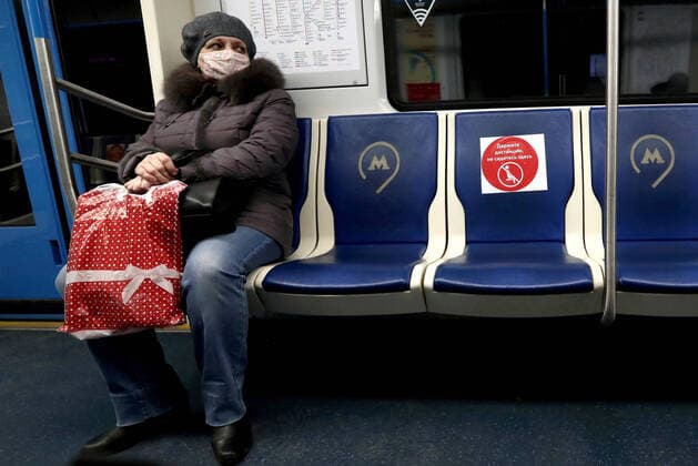 MOSCOW, RUSSIA - APRIL 2, 2020: A woman on a Moscow Metro train. The Moscow authorities imposed home isolation for all Moscow residents, regardless of their age, and restrictions on movement within the city, effective since March 30, 2020, as a measure to contain the spread of the COVID-19 coronavirus infection. Violations of the stay-at-home order carry fines ranging from 1,000 to 40,000 rubles for non-infected people, and up to 1m rubles or imprisonment for up to 3 years for infected people, depending on the severity of consequences. Stanislav Krasilnikov TASS TS0D43AE