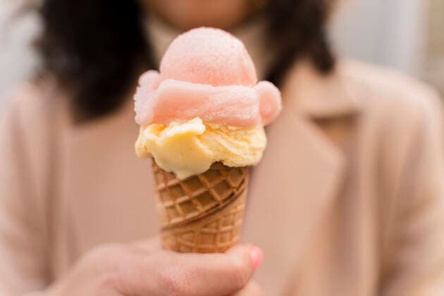 Creative Highlights Symbol Close-up of woman holding an ice cream cone model released Symbolfoto  FMOF00922