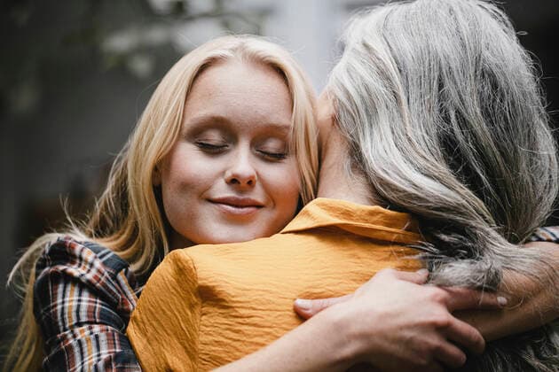 Portrait of adult daughter embracing mother outdoors model released Symbolfoto property released  GUSF03463