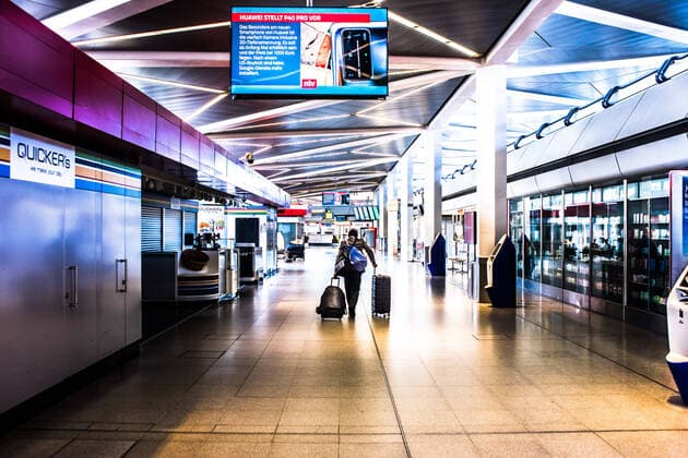 Airport Tegel, TXL A man pulls his suitcases lonely through the empty aisle of Tegel Airport Berlin Tegel Otto Lilienthal Airport is only operated to a very limited extent due to the corona crisis; there is a total emptiness in f