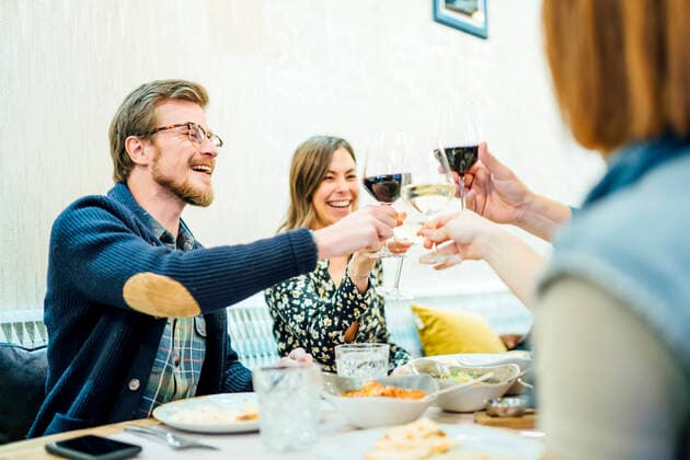 Friends dining in an Indian restaurant, toasting wine glasses model released Symbolfoto property released  OCMF01035