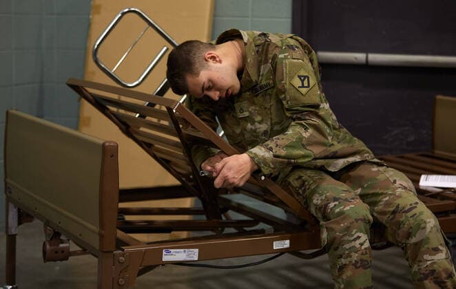 April 2, 2020, Worcester, Massachusetts, US: The Massachusetts National Guard in cooperation with FEMA and Umass Memorial Medical Cenetr are building a COVID-19, Corona Virus, field hospital to treat midlly ill paitents at the DCU Center in Worcester, Massachusetts. The facility will have 250 beds for those who are too sick to be home, but not in need of an Intensive Care Unit. Soldiers assemble a hospital bed. Worcester US - ZUMAd211 20200402_zap_d211_019 Copyright: xAllisonxDinnerx