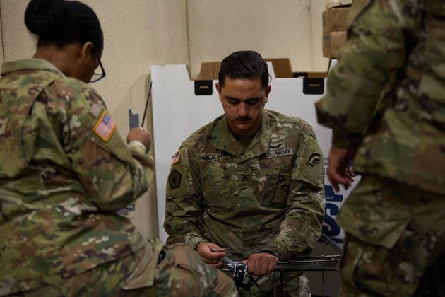 April 2, 2020, Worcester, Massachusetts, US: The Massachusetts National Guard in cooperation with FEMA and Umass Memorial Medical Cenetr are building a COVID-19, Corona Virus, field hospital to treat midlly ill paitents at the DCU Center in Worcester, Massachusetts. The facility will have 250 beds for those who are too sick to be home, but not in need of an Intensive Care Unit. Soldiers assemble laundry carts and trash cans to be used. Worcester US - ZUMAd211 20200402_zap_d211_018 Copyright: xAllisonxDinnerx
