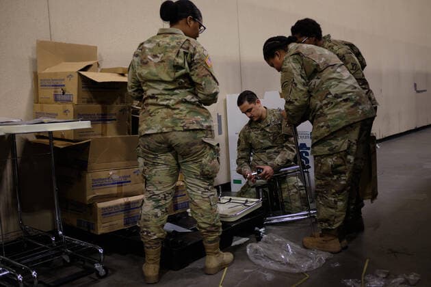 April 2, 2020, Worcester, Massachusetts, US: The Massachusetts National Guard in cooperation with FEMA and Umass Memorial Medical Cenetr are building a COVID-19, Corona Virus, field hospital to treat midlly ill paitents at the DCU Center in Worcester, Massachusetts. The facility will have 250 beds for those who are too sick to be home, but not in need of an Intensive Care Unit. Soldiers assemble laundry carts and trash cans to be used. Worcester US - ZUMAd211 20200402_zap_d211_006 Copyright: xAllisonxDinnerx