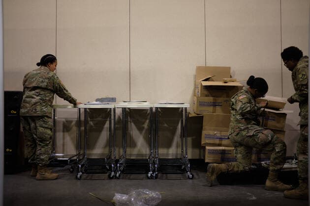 April 2, 2020, Worcester, Massachusetts, US: The Massachusetts National Guard in cooperation with FEMA and Umass Memorial Medical Cenetr are building a COVID-19, Corona Virus, field hospital to treat midlly ill paitents at the DCU Center in Worcester, Massachusetts. The facility will have 250 beds for those who are too sick to be home, but not in need of an Intensive Care Unit. Soldiers assemble laundry carts and trash cans to be used. Worcester US - ZUMAd211 20200402_zap_d211_008 Copyright: xAllisonxDinnerx